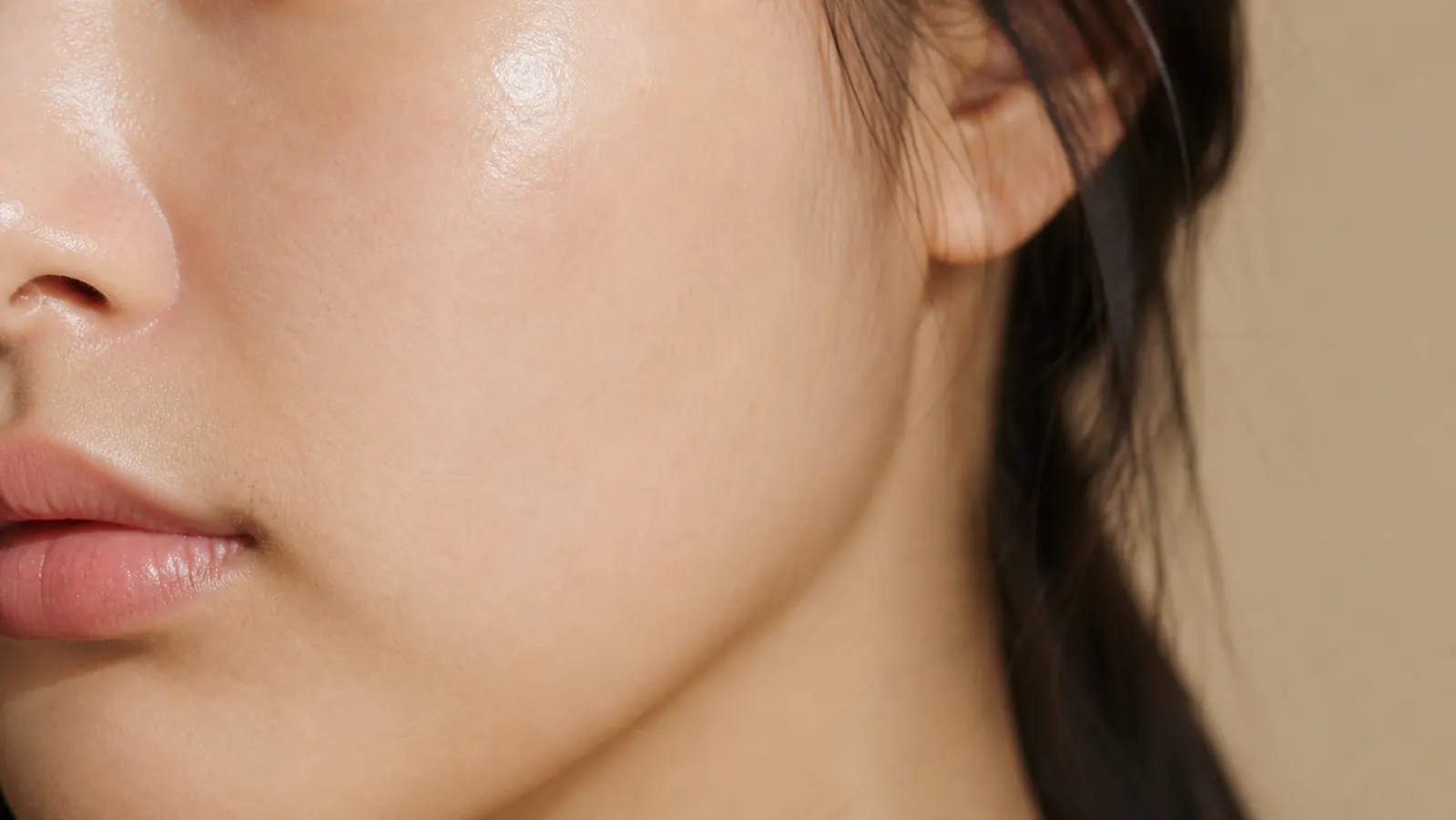 Close-up of glowing, even-toned skin after consistent PDRN essence use, no makeup, natural light